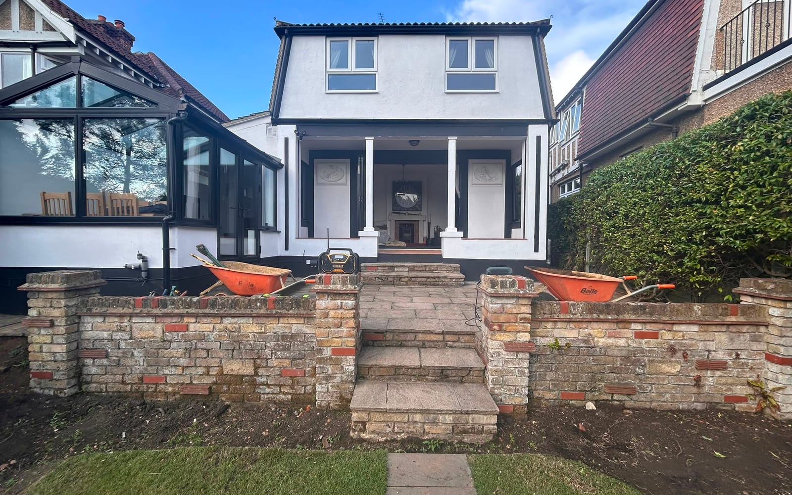 A rear garden dug out with brick retaining walls ready for a new patio by Hills Driveways & Patios